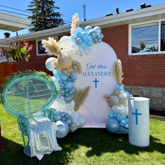 Boho christening backdrop with large vinyl god bless sign and white display plinth Calgary event decor