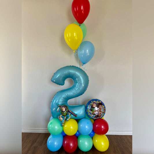 Colorful balloon arrangement with a number foil balloon and toy-themed decorations in Calgary