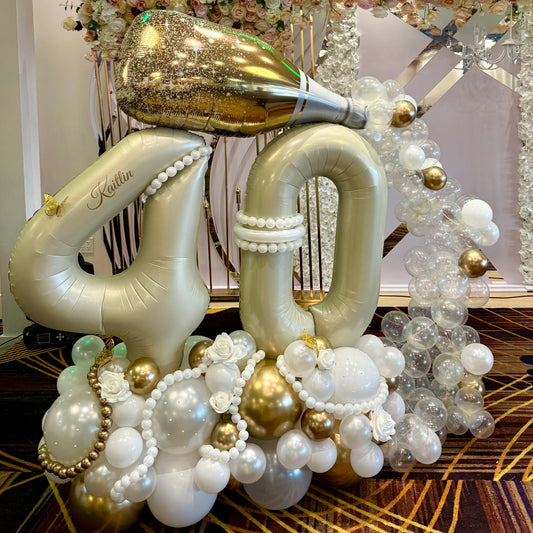 Custom vinyl name on jumbo gold 40 balloon stack with faux roses and balloon pearls Calgary