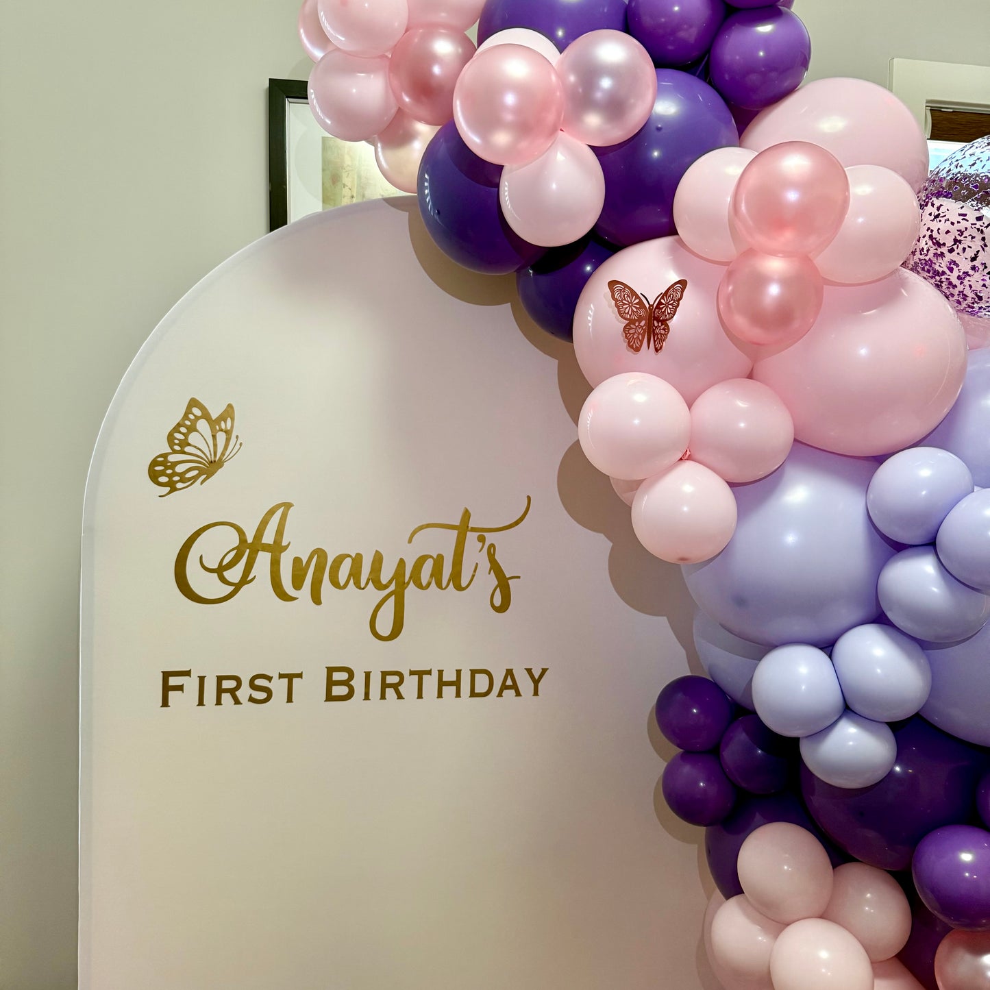 Balloon arch in pink, purple, lilac colours and butterfly decorations