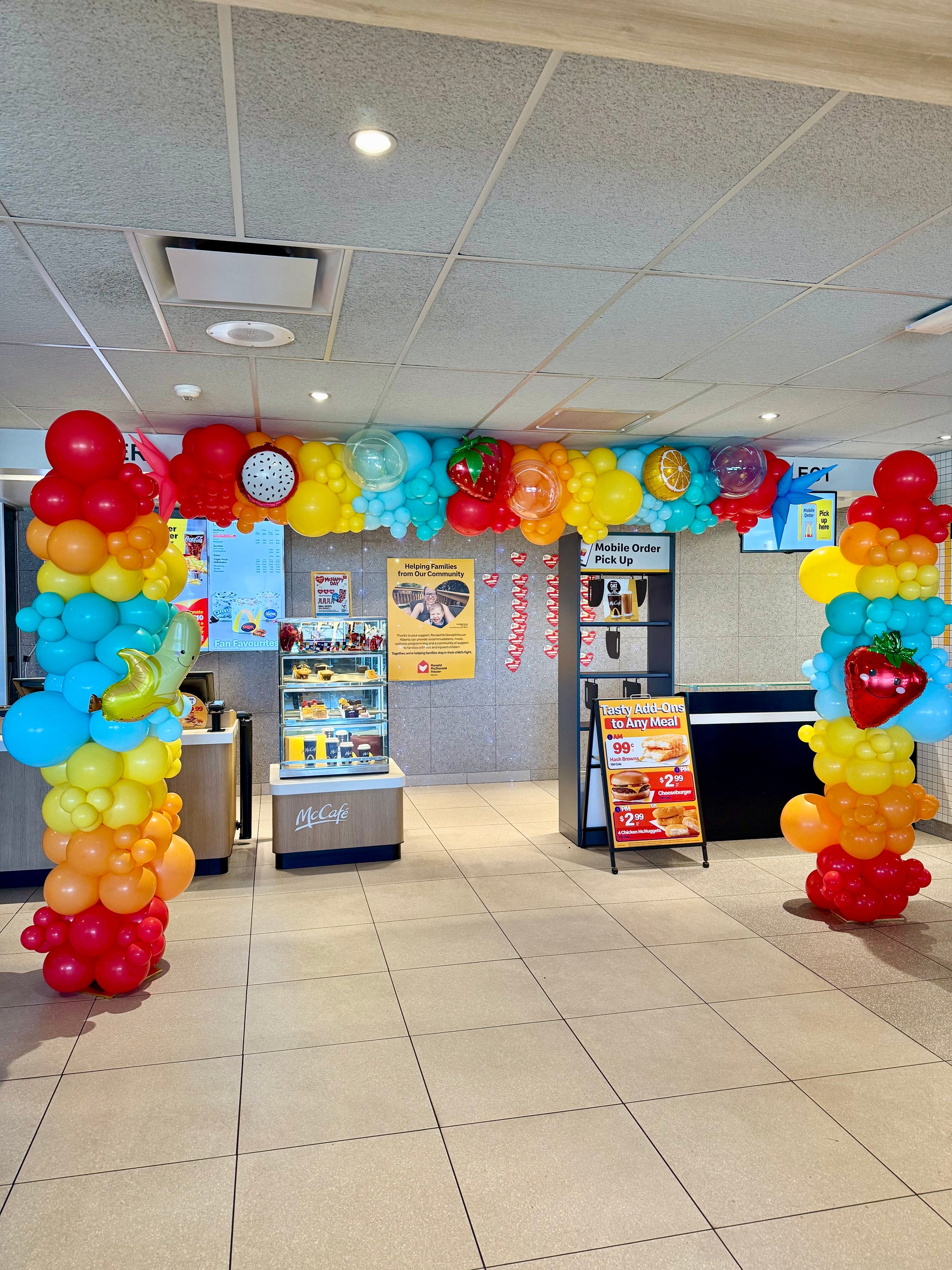 Colorful balloon archway in a fast-food restaurant interior