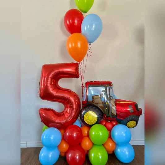 Colorful balloons with a large red number  and a toy truck for kids birthday in Calgary