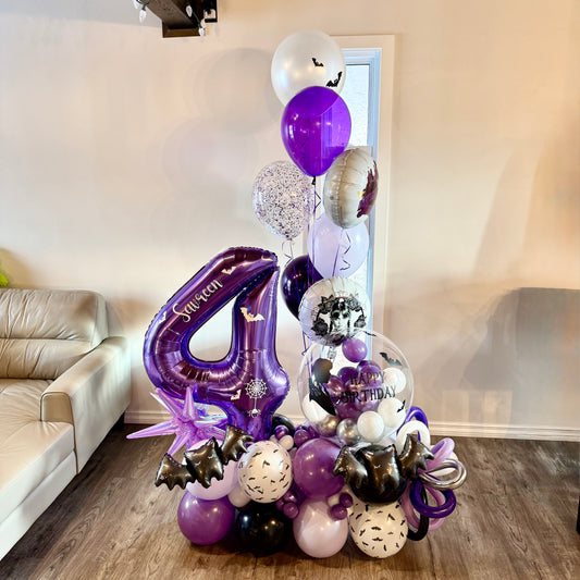 Wednesday Addams theme purple and black balloon marquee with jumbo number 4 for Calgary kids birthday