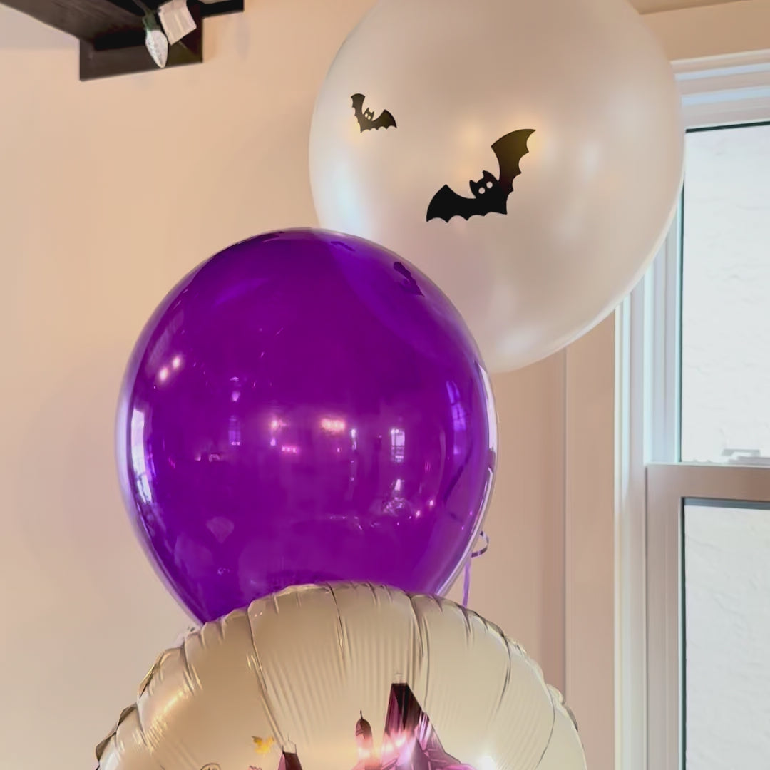 Video showcase of custom Wednesday theme purple balloon stack with floating helium bouquet Calgary