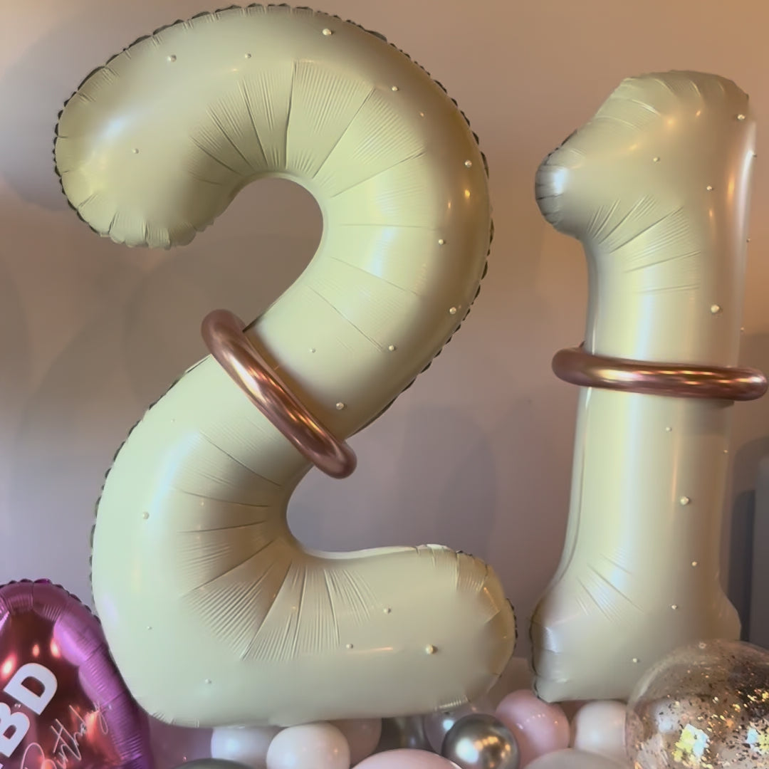 Close up video showing silver confetti and rose gold details on custom birthday balloon stack Calgary