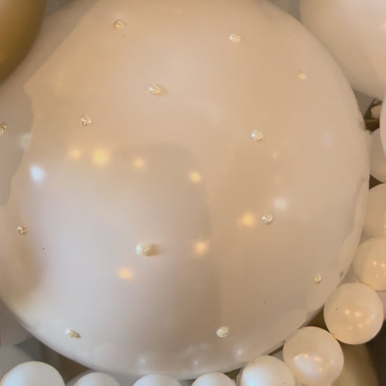 Close up video showing custom vinyl name and floral details on satin gold 40 balloon marquee Calgary